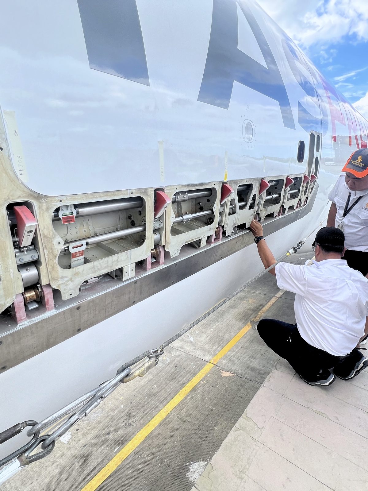 VTAM engineers inspecting an aircraft fuselage on site