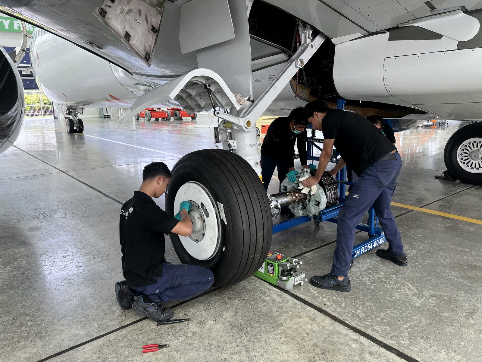 Engineers servicing an aircraft main landing gear on site in Vietnam